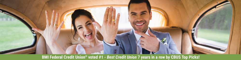 smiling couple just married in back seat of car