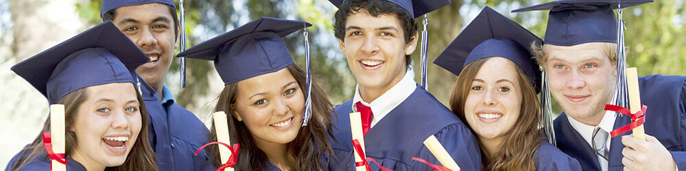 Graduates smiling with their diplomas