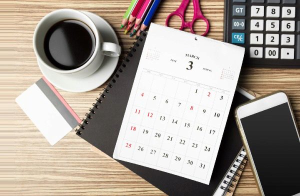 day planner, coffee, and office supplies
