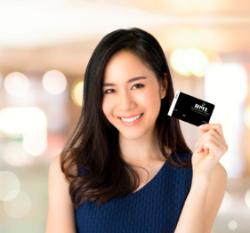 girl holding debit card and smiling