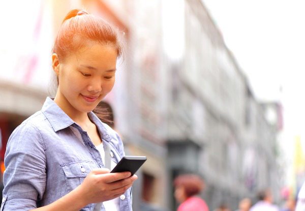girl with mobile phone smiling