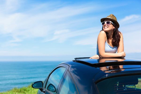 woman standing in car with sun roof